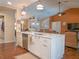 Modern kitchen featuring white cabinetry, stainless steel appliances, and a view into the living room at 5343 Sagamore Ct, New Port Richey, FL 34655