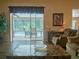 Bright living room with access to a screened-in lanai and pool area, blending indoor/outdoor living at 5343 Sagamore Ct, New Port Richey, FL 34655