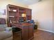 Home office with a large desk, chair, built-in shelving, and hardwood flooring at 5343 Sagamore Ct, New Port Richey, FL 34655