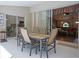 Covered outdoor patio with dining table, seating area, and views of the interior at 5343 Sagamore Ct, New Port Richey, FL 34655