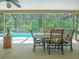 The screened in pool with patio furniture and lush green backyard at 5343 Sagamore Ct, New Port Richey, FL 34655