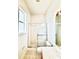 Bright bathroom featuring a tiled shower with glass door and a vanity with ample countertop space at 5525 Thorngrove Way, Spring Hill, FL 34609