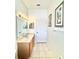 Bathroom with a vanity, decorative mirrors, and a shower visible through the doorway, exuding elegance at 5525 Thorngrove Way, Spring Hill, FL 34609