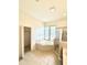 Bathroom with a soaking tub and shower with a bright window, along with a walk-in closet at 5525 Thorngrove Way, Spring Hill, FL 34609