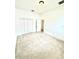 Well-lit bedroom with neutral carpet and a closet, creating a comfortable and inviting atmosphere at 5525 Thorngrove Way, Spring Hill, FL 34609