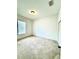 Neutral carpeted bedroom features a bright window and a closet for storage at 5525 Thorngrove Way, Spring Hill, FL 34609