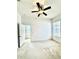 Bright bedroom with carpet flooring, ceiling fan, and two windows at 5525 Thorngrove Way, Spring Hill, FL 34609
