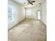 Bright bedroom with multiple windows, a ceiling fan, and a sliding glass door for natural light and access at 5525 Thorngrove Way, Spring Hill, FL 34609