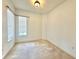 Well-lit bedroom with neutral carpeting, white walls, and two windows at 5525 Thorngrove Way, Spring Hill, FL 34609