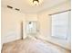 Cozy bedroom featuring neutral carpet, white walls, and natural light at 5525 Thorngrove Way, Spring Hill, FL 34609