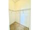 Walk-in closet with metal shelving and carpet flooring at 5525 Thorngrove Way, Spring Hill, FL 34609