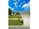 Beautiful single-story home with a well-kept lawn, brick driveway, and a spacious two-car garage at 5525 Thorngrove Way, Spring Hill, FL 34609