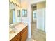 Hallway view showcasing a bathroom, rooms, and carpeted floor creating a seamless transition throughout the home at 5525 Thorngrove Way, Spring Hill, FL 34609