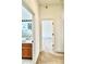 Hallway view with bathroom on the left and bedroom on the right, showcasing the home's layout at 5525 Thorngrove Way, Spring Hill, FL 34609