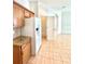 Kitchen featuring white refrigerator, wooden cabinets, and access to pantry at 5525 Thorngrove Way, Spring Hill, FL 34609