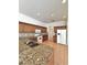 Spacious kitchen with stainless steel sink, granite countertops, and wooden cabinets at 5525 Thorngrove Way, Spring Hill, FL 34609
