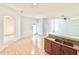 Open kitchen featuring tiled flooring, an island, and a combined dining area at 5525 Thorngrove Way, Spring Hill, FL 34609