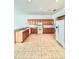 Eat-in kitchen featuring tile floors, wood cabinets, and granite countertops at 5525 Thorngrove Way, Spring Hill, FL 34609
