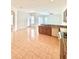 Bright kitchen features an island, tiled flooring, wood cabinets, and a dishwasher at 5525 Thorngrove Way, Spring Hill, FL 34609