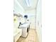 Bright laundry room featuring a modern washer and dryer, with tile floor and storage shelves at 5525 Thorngrove Way, Spring Hill, FL 34609