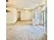 Inviting living room featuring plush carpeting, contemporary lighting fixtures, and an open layout at 5525 Thorngrove Way, Spring Hill, FL 34609