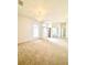 Spacious living room with plush carpeting, elegant lighting, and an open design at 5525 Thorngrove Way, Spring Hill, FL 34609
