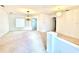 Bright living room with plush carpeting, modern lighting, and an open floor plan at 5525 Thorngrove Way, Spring Hill, FL 34609