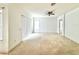 Bright living room with carpet, ceiling fan, and sliding door access at 5525 Thorngrove Way, Spring Hill, FL 34609