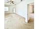 A cozy living room with beige carpeting, ceiling fan and a glass panel door at 5525 Thorngrove Way, Spring Hill, FL 34609