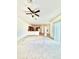 Spacious living room with carpet flooring, ceiling fan and kitchen view at 5525 Thorngrove Way, Spring Hill, FL 34609