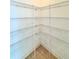 Walk-in pantry with metal shelving and tile floor at 5525 Thorngrove Way, Spring Hill, FL 34609