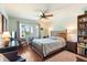 Inviting bedroom featuring hardwood floors, a ceiling fan, and bright natural light at 620 Edgewater Dr # 501, Dunedin, FL 34698