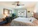 Comfortable bedroom with a large window, ceiling fan, and stylish decor at 620 Edgewater Dr # 501, Dunedin, FL 34698