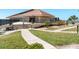 Exterior shot of building with walkway and grass at 620 Edgewater Dr # 501, Dunedin, FL 34698