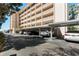 Condominium carport featuring assigned parking spots and shade from the sun at 620 Edgewater Dr # 501, Dunedin, FL 34698