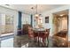 Charming dining area features elegant décor, marble floors, and an eye-catching hanging light fixture at 620 Edgewater Dr # 501, Dunedin, FL 34698