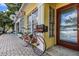 Charming yellow building with a bike parked outside on a brick sidewalk with a store front visible at 620 Edgewater Dr # 501, Dunedin, FL 34698