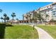 Exterior shot of building with manicured lawn and pool at 620 Edgewater Dr # 501, Dunedin, FL 34698