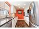 Modern kitchen featuring stainless steel appliances, granite countertops, and rich flooring at 620 Edgewater Dr # 501, Dunedin, FL 34698
