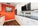 Updated kitchen with white cabinets, stainless steel microwave, and unique backsplash details at 620 Edgewater Dr # 501, Dunedin, FL 34698