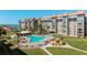 Aerial view of a beautiful outdoor pool and condo building at 620 Edgewater Dr # 501, Dunedin, FL 34698