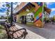Charming storefronts with vibrant designs along a brick-paved street, offering unique shopping experiences at 620 Edgewater Dr # 501, Dunedin, FL 34698