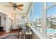 Bright sunroom with large windows offering community and water views, plus a ceiling fan at 620 Edgewater Dr # 501, Dunedin, FL 34698
