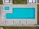 An aerial view of the pool and deck area with lounge seating and jacuzzi at 6343 92Nd N Pl # 2102, Pinellas Park, FL 33782