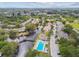 Aerial view of community with lush landscaping, a community pool, and waterfront views at 6343 92Nd N Pl # 2102, Pinellas Park, FL 33782
