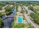 An aerial view of the neighborhood showing a community pool, long bridge, and waterway at 6343 92Nd N Pl # 2102, Pinellas Park, FL 33782