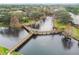 An aerial view of a neighborhood water feature with a wooden bridge and gazebo at 6343 92Nd N Pl # 2102, Pinellas Park, FL 33782