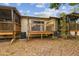 A wooden back patio gives access to outdoor living in a lush green space for relaxation and entertaining at 6343 92Nd N Pl # 2102, Pinellas Park, FL 33782