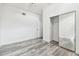 Bedroom boasts gray wood-look flooring and closet with mirrored doors at 6343 92Nd N Pl # 2102, Pinellas Park, FL 33782