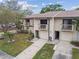 Well-maintained townhome with a private balcony, a garage, and lush landscaping at 6343 92Nd N Pl # 2102, Pinellas Park, FL 33782